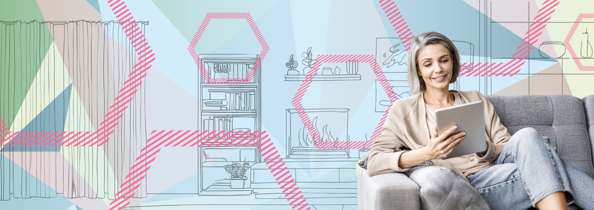 Frau sitzt mit einem Tablet auf einem grauen Sofa.